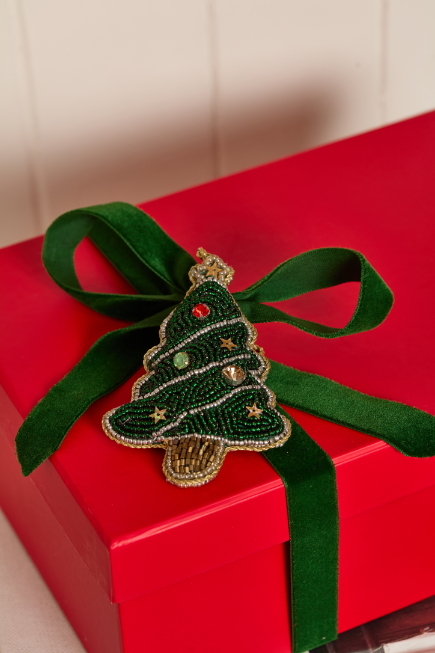 Christmas present wrapped in red paper and green ribbon