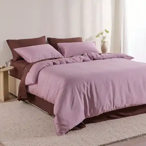 A bed styled with a dusty violet bamboo cotton quilt cover set and a chocolate bamboo cotton sheet set