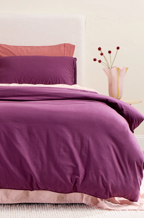 Vivid plum quilt cover set with pearl blush sheet set.