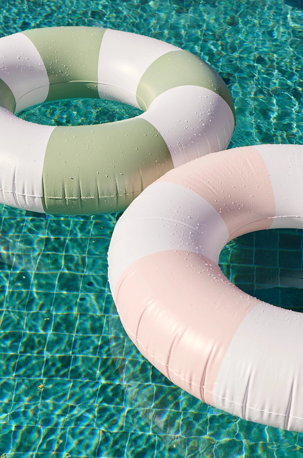 Green striped and pink striped circle pool floaties