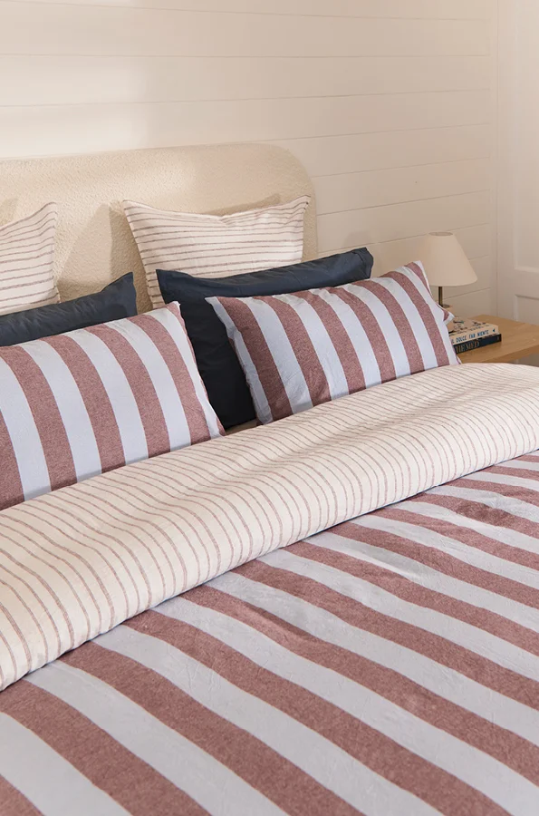 Blue and chocolate striped quilt cover set on queen bed